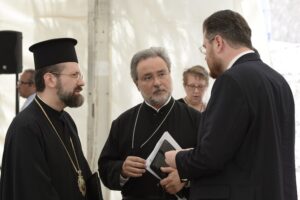 Archdeacon John Chryssavgis (CENTER) and Archbishop Job of Telemessos of the Ecumenical Patriarchate in conversation with Dr Ionut Mavrichi of the Press Office of the Patriarchate of Romania at the Press Briefing on the first day of the Holy and Great Council. PHOTO: © JOHN MINDALA.