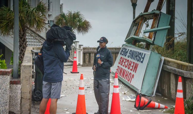 A local TV news reporter gives a live update in front of the generations-old Johnnie Mercers Pier sign as it lies in ruins after being lashed by Tropical Storm Debby while it makes it's way up the eastern US seaboard.

Wrightsville Beach, NC, USA
8-8-2024